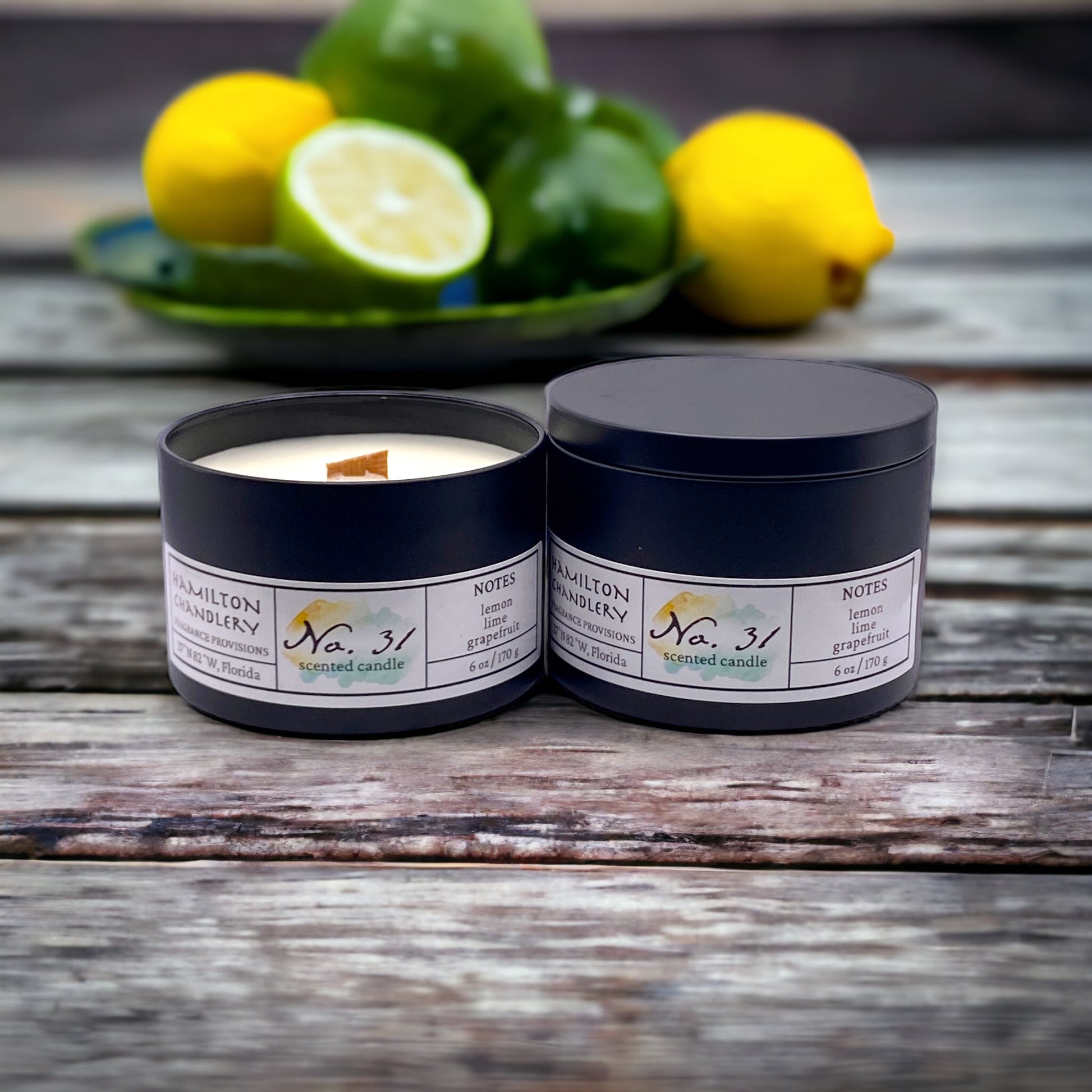 Fragrance No. 31 Travel Tin Candles on Wooden Table with Fresh Citrus in Background | Hamilton Chandlery